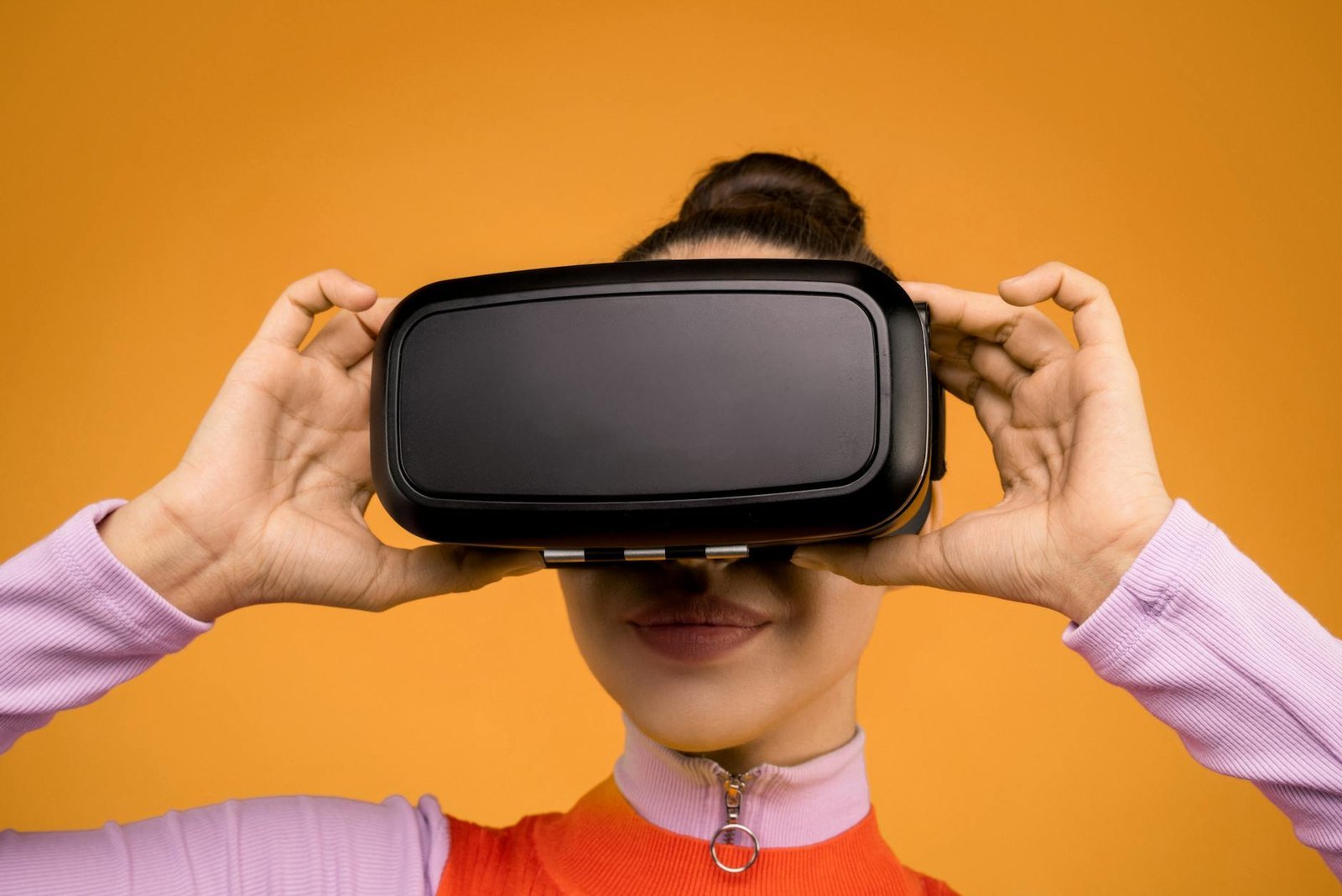 woman in long sleeve shirt holding vr headset